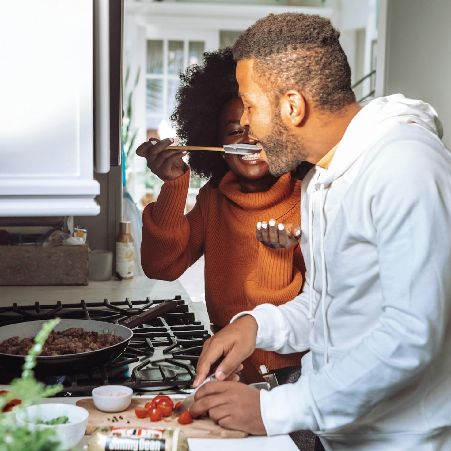 Community members collaborating in a modern kitchen, sharing recipes and techniques